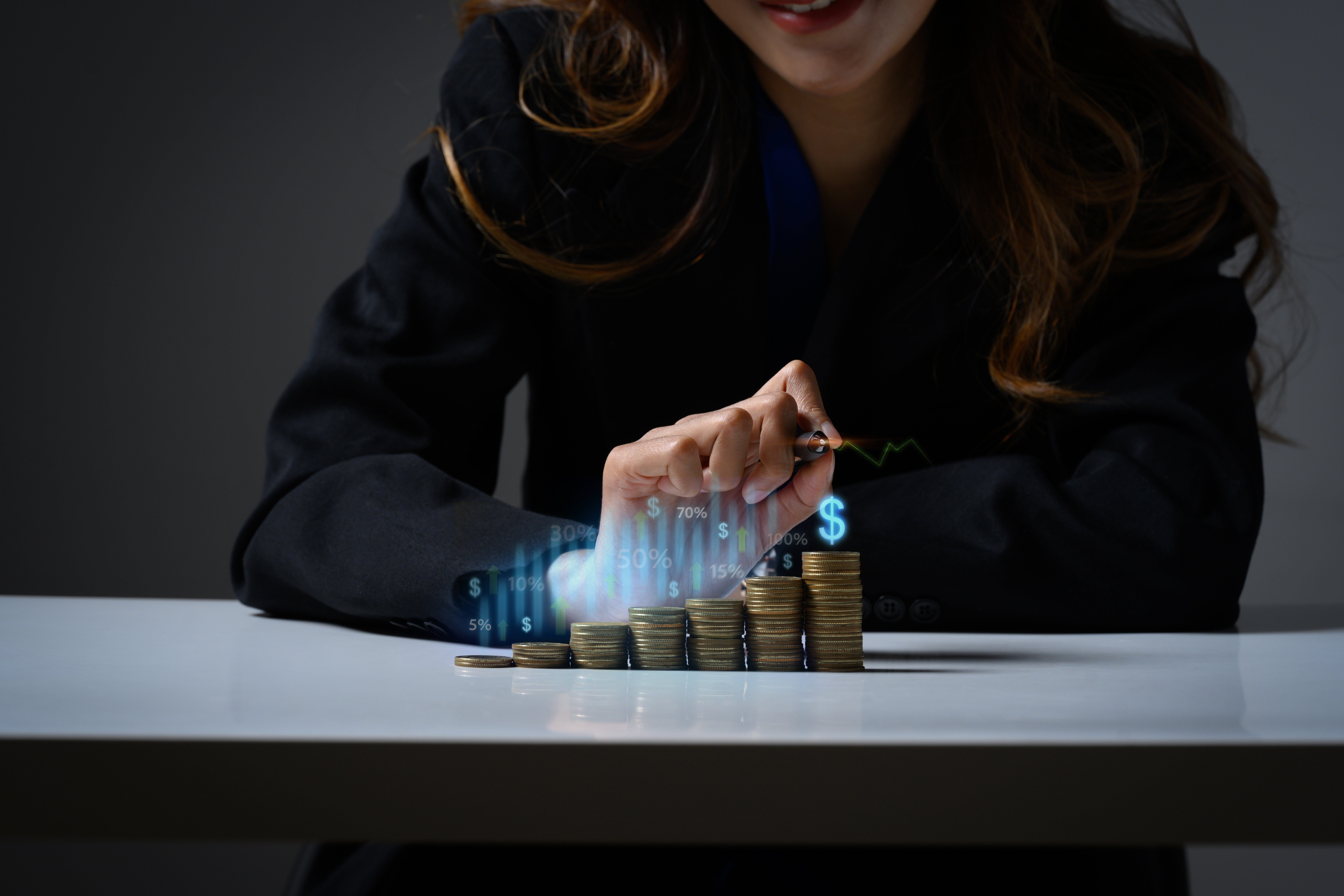 businesswoman-with-stacks-coins-futuristic-holographic-graphics-symbols-savings-long-term-investment-concept