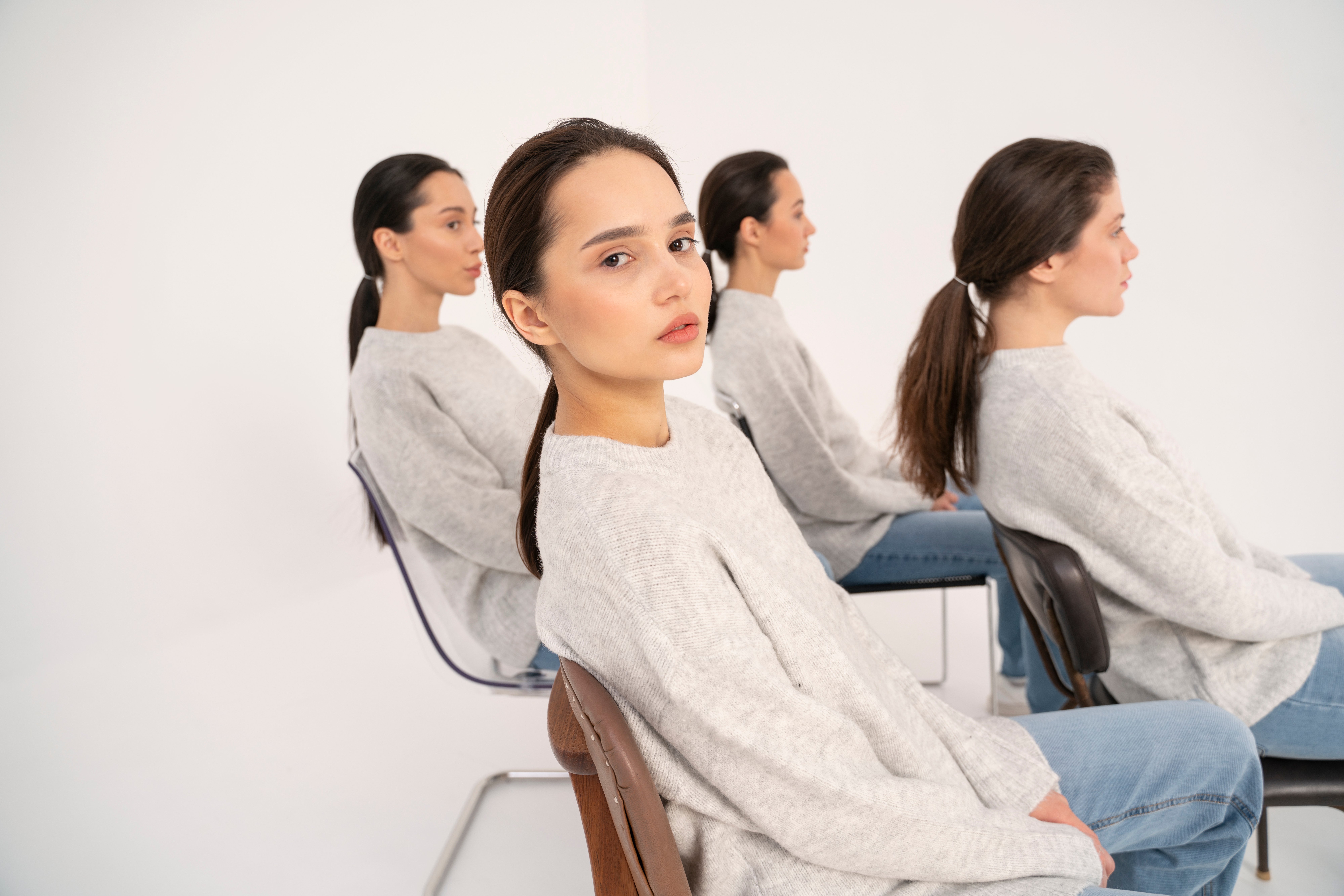 side-view-women-sweaters-jeans-posing-minimalistic-portraits-chairs