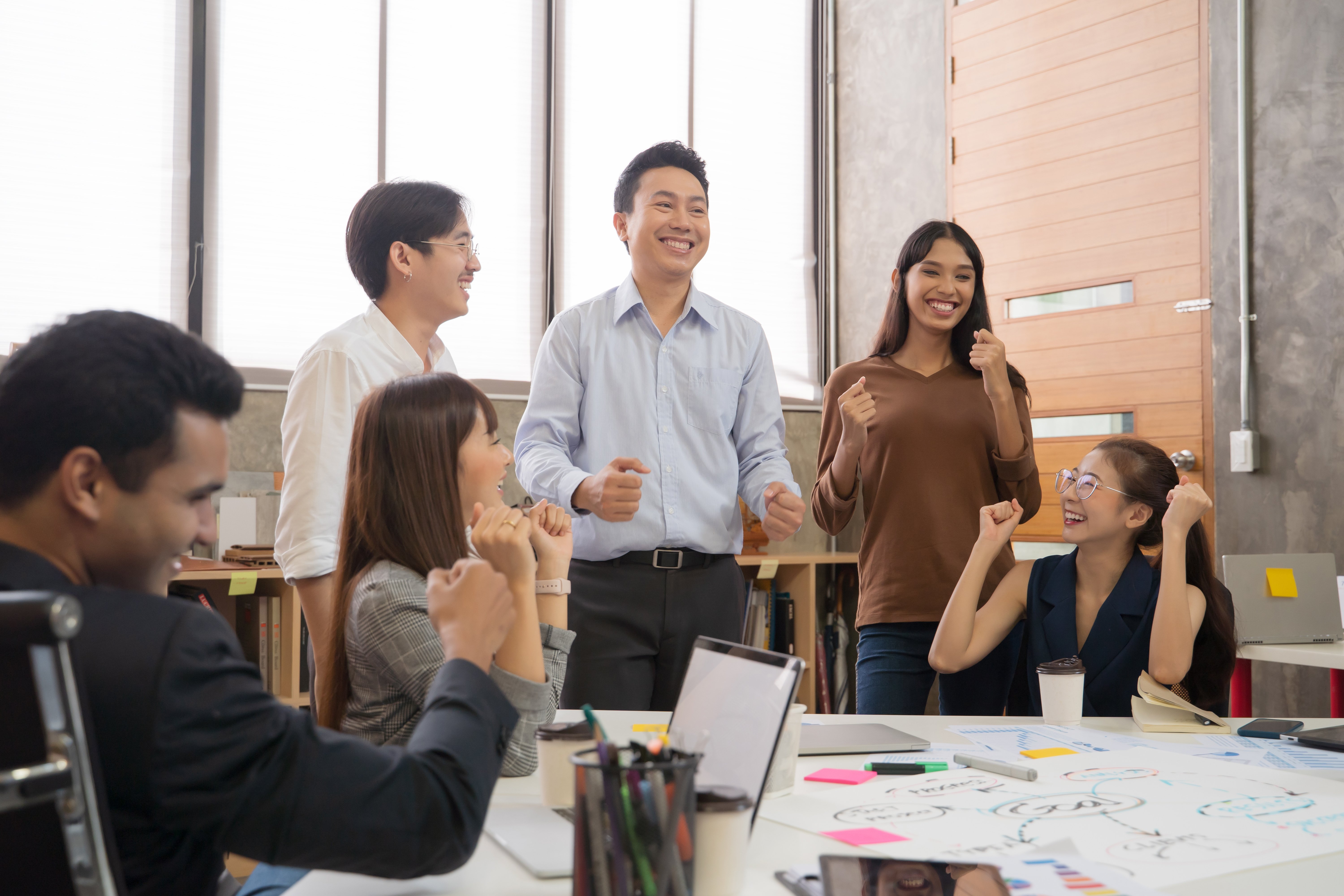 smiling-business-people-discussing-table-office